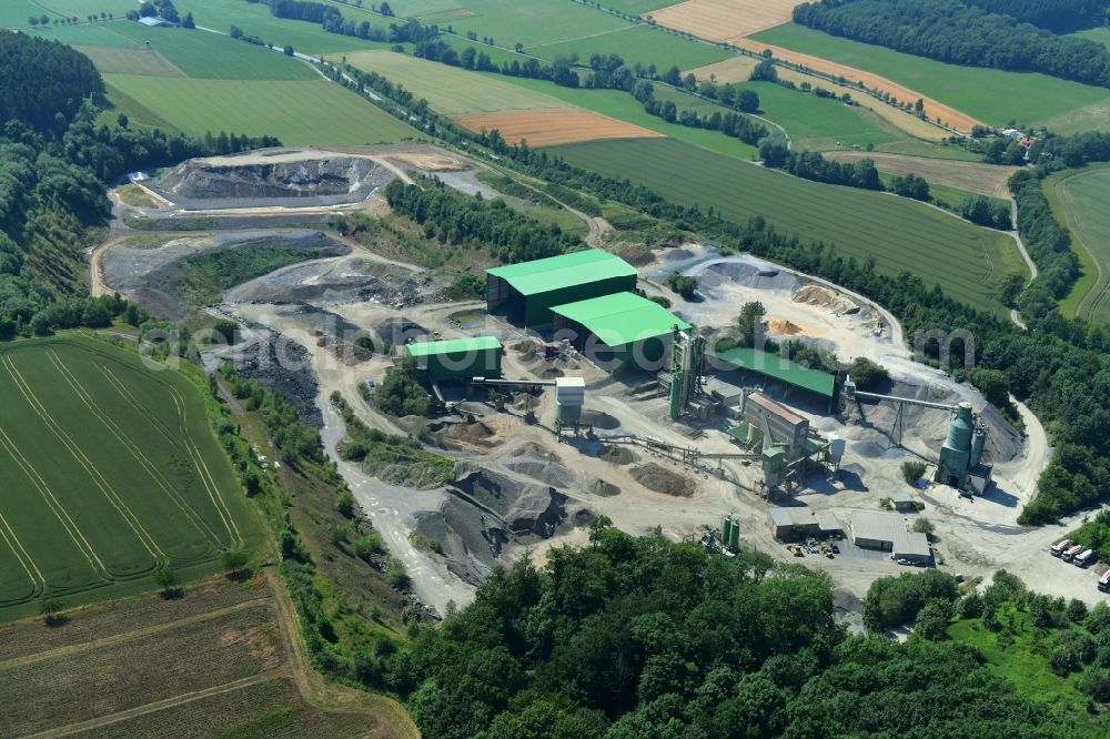Sundern (Sauerland) from the bird's eye view: Quarry for the mining and handling of limestone in the district Hellefeld in Sundern (Sauerland) in the state North Rhine-Westphalia, Germany