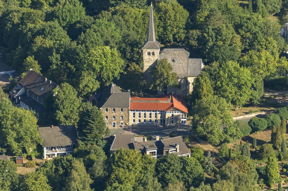 Aerial photograph Bochum - Stiepeler village church in Bochum in the Ruhr district Stiepelmann in North Rhine-Westphalia. The church is a cultural monument and is surrounded by trees and houses