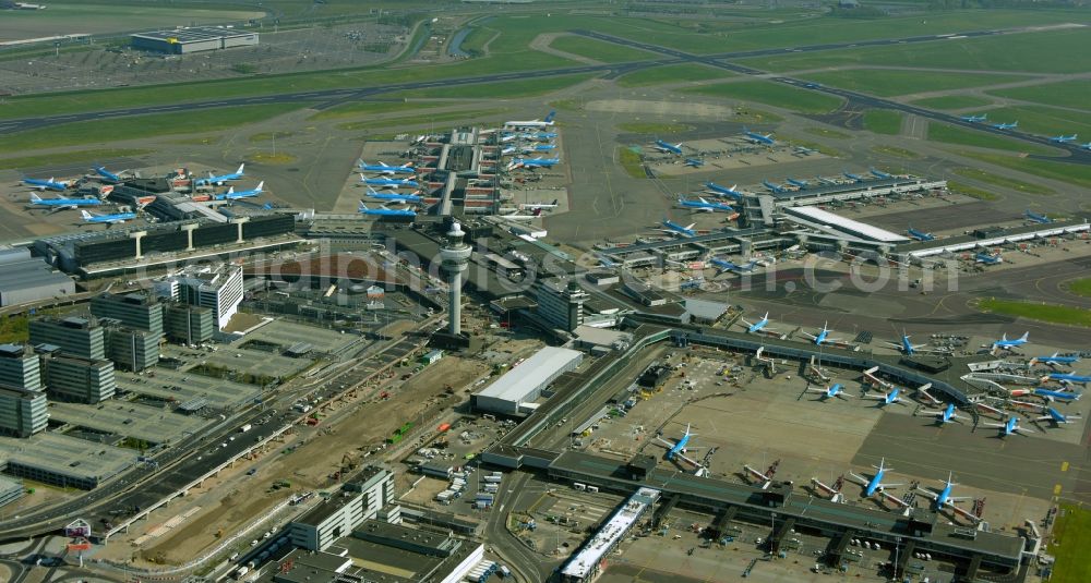 Aerial photograph Schiphol - Blue passenger aircraft of KLM Royal Dutch Airlines decommissioned at the handling buildings and terminals on the grounds of the airport in Schiphol in Noord-Holland, the Netherlands