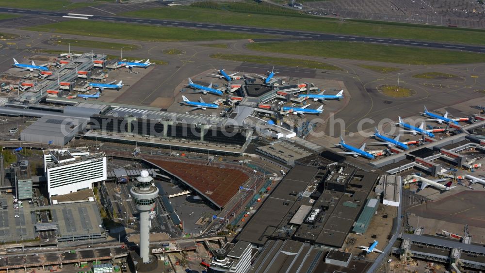 Aerial photograph Schiphol - Blue passenger aircraft of KLM Royal Dutch Airlines decommissioned at the handling buildings and terminals on the grounds of the airport in Schiphol in Noord-Holland, the Netherlands
