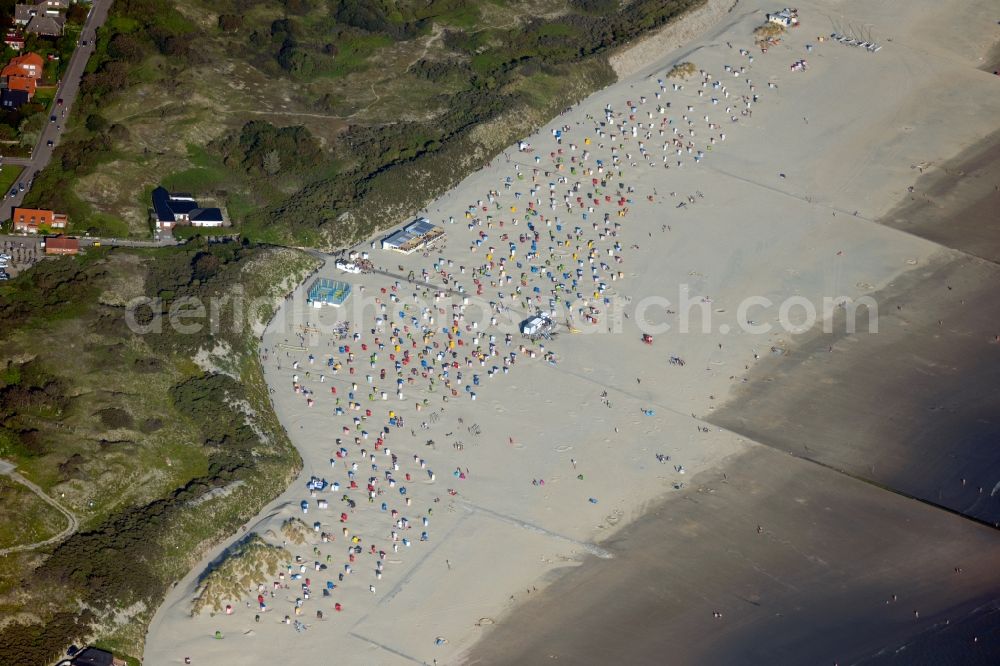 Aerial image Borkum - Beach chair on the sandy beach ranks in the coastal area of the North Sea at the edge of the residential area of Borkum in the state Lower Saxony