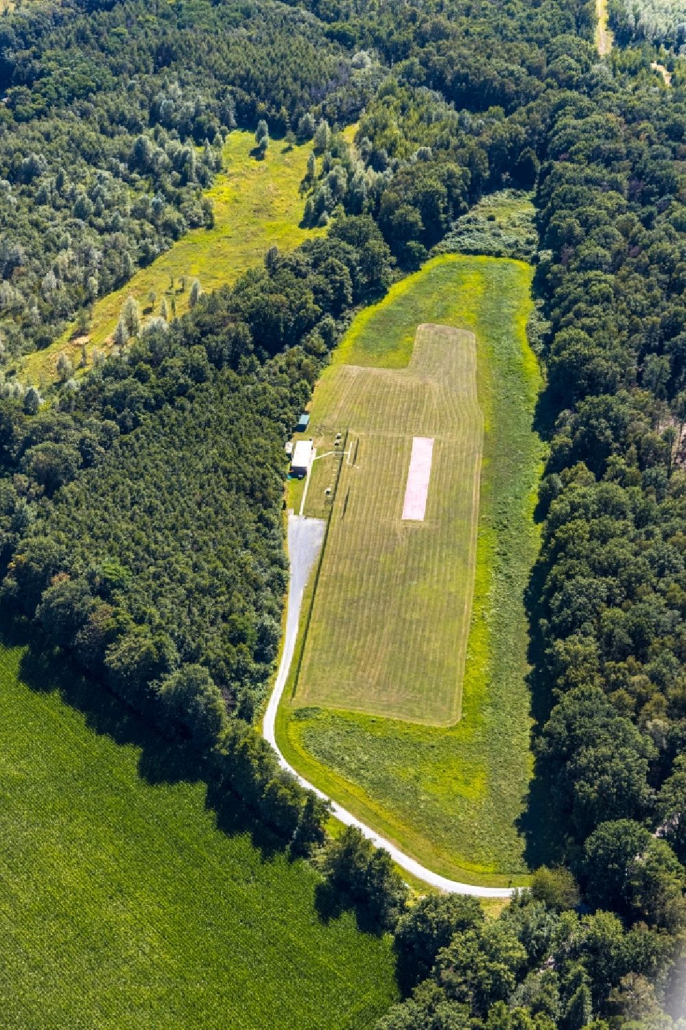 Bottrop from the bird's eye view: Structures on agricultural fields surrounded by forest in Bottrop in the state North Rhine-Westphalia, Germany