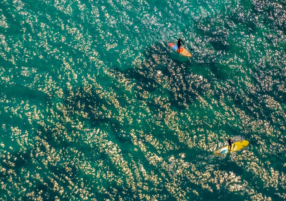 Son Real from the bird's eye view: SUP board sport boat in motion on the water surface in the bay of Alcudia in Son Real in Balearic island of Mallorca, Spain