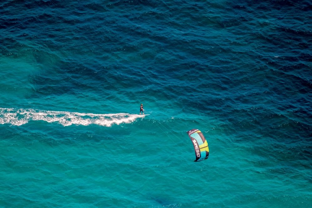 Son Serra de Marina from above - Surfer - kitesurfer in motion in the bay of Alcudia in Son Serra de Marina in Balearic island of Mallorca, Spain