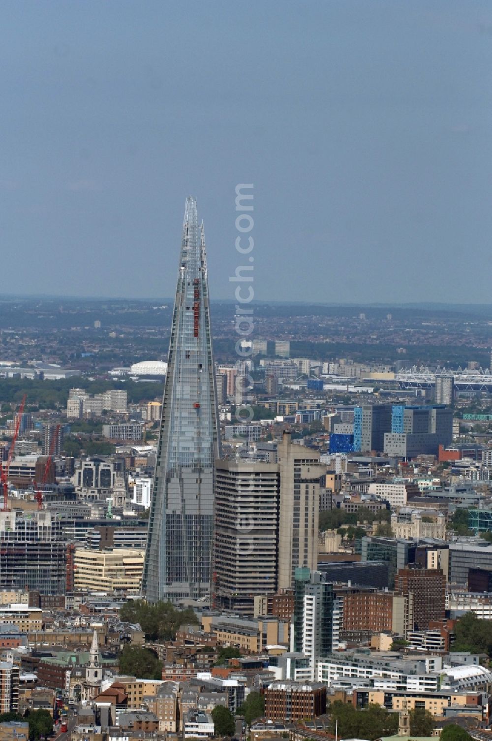 Aerial photograph London - View The Shard - Europe's tallest building. The high-rise occurs at the London Bridge Station. The Shard London Bridge (formerly known as London Bridge Tower, and Shard of Glass) is a skyscraper under construction in London, which will be on its completion as it stood at 310 meters, the second tallest building in Europe