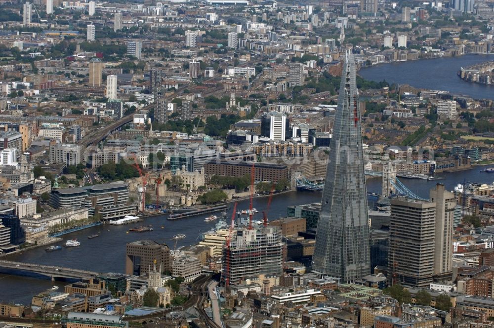 London from above - View The Shard - Europe's tallest building. The high-rise occurs at the London Bridge Station. The Shard London Bridge (formerly known as London Bridge Tower, and Shard of Glass) is a skyscraper under construction in London, which will be on its completion as it stood at 310 meters, the second tallest building in Europe