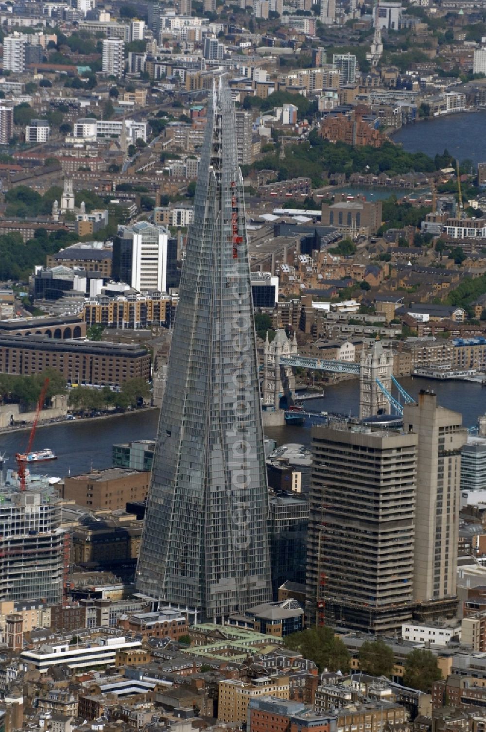London from the bird's eye view: View The Shard - Europe's tallest building. The high-rise occurs at the London Bridge Station. The Shard London Bridge (formerly known as London Bridge Tower, and Shard of Glass) is a skyscraper under construction in London, which will be on its completion as it stood at 310 meters, the second tallest building in Europe