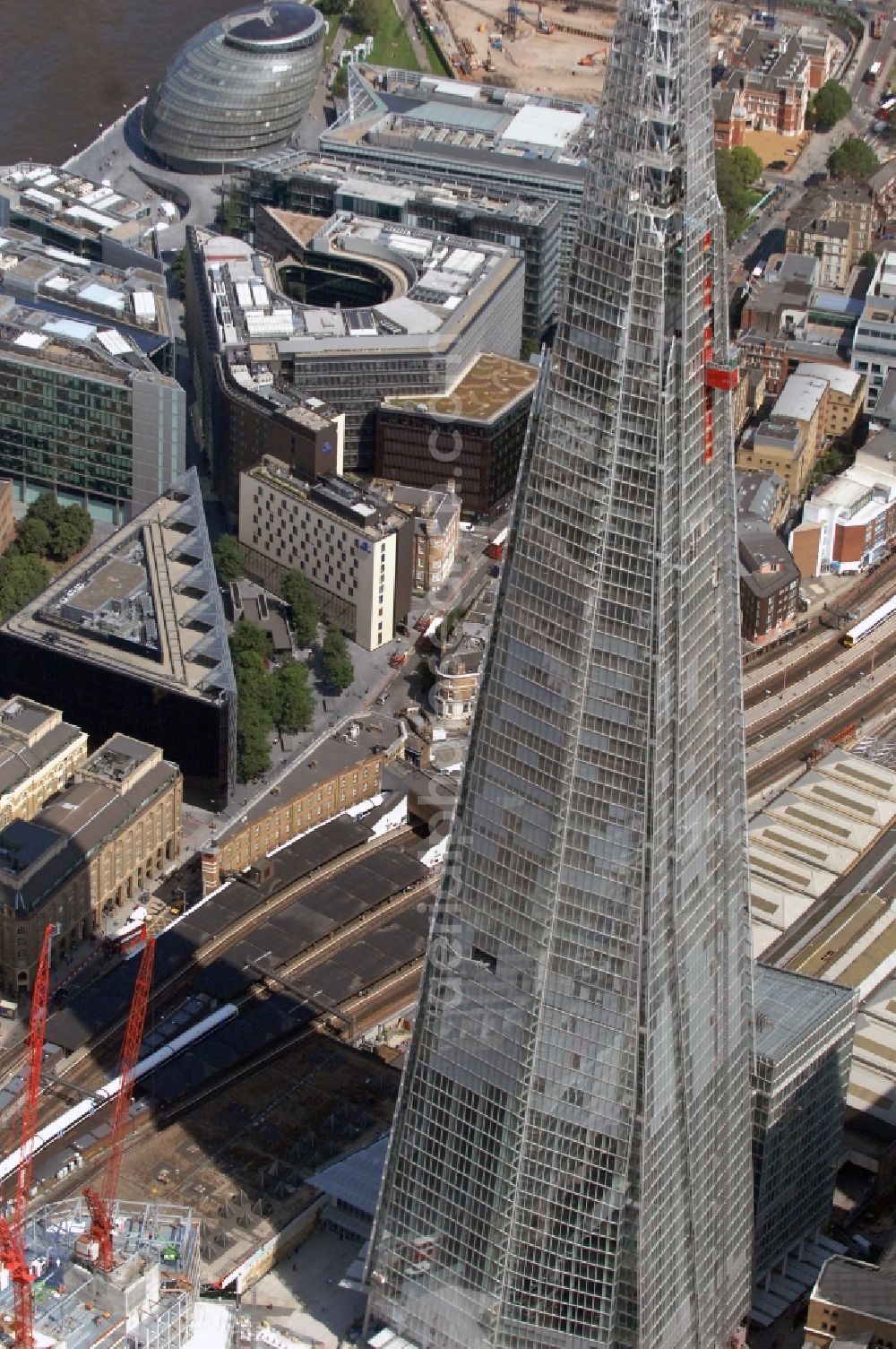 Aerial image London - View The Shard - Europe's tallest building. The high-rise occurs at the London Bridge Station. The Shard London Bridge (formerly known as London Bridge Tower, and Shard of Glass) is a skyscraper under construction in London, which will be on its completion as it stood at 310 meters, the second tallest building in Europe