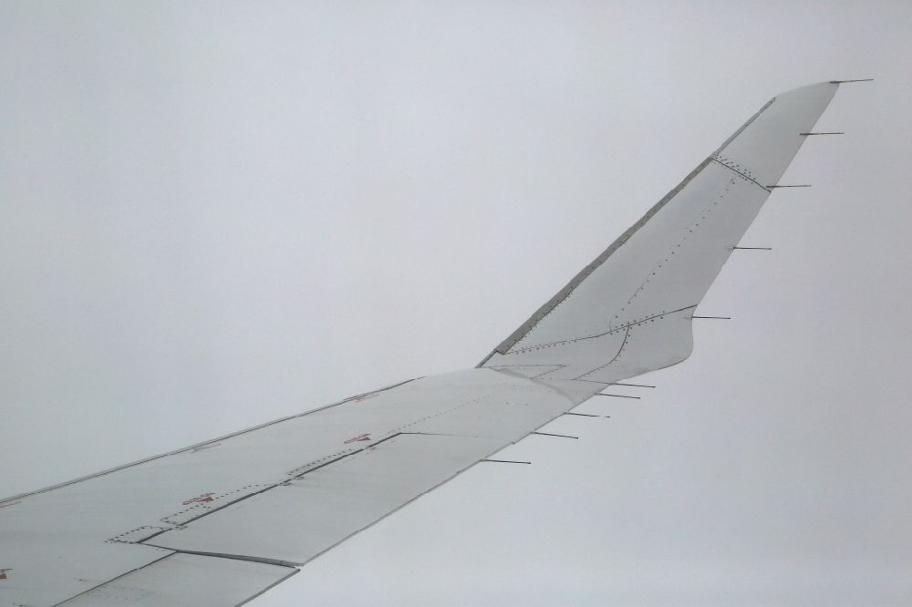 Aerial image Singen (Hohentwiel) - The wing of a Bombardier CRJ900 Lufthansa CityLine airliner in flight in the clouds above Singen (Hohentwiel) in the state of Baden- Wuerttemberg
