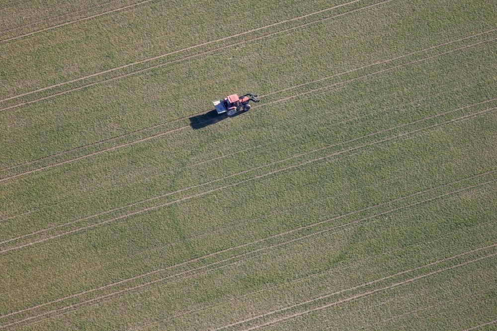 München from the bird's eye view: Tractor in field work on the outskirts of Freiham in Munich in Bavaria