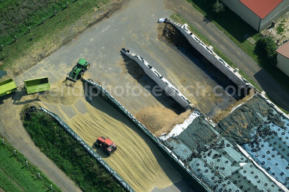 Zschepplin from above - Tractors on a farm and agricultural estate on the edge of Zschepplin in the state of Saxony. The compound with its halls and agricultural facilities is located in the North of the borough