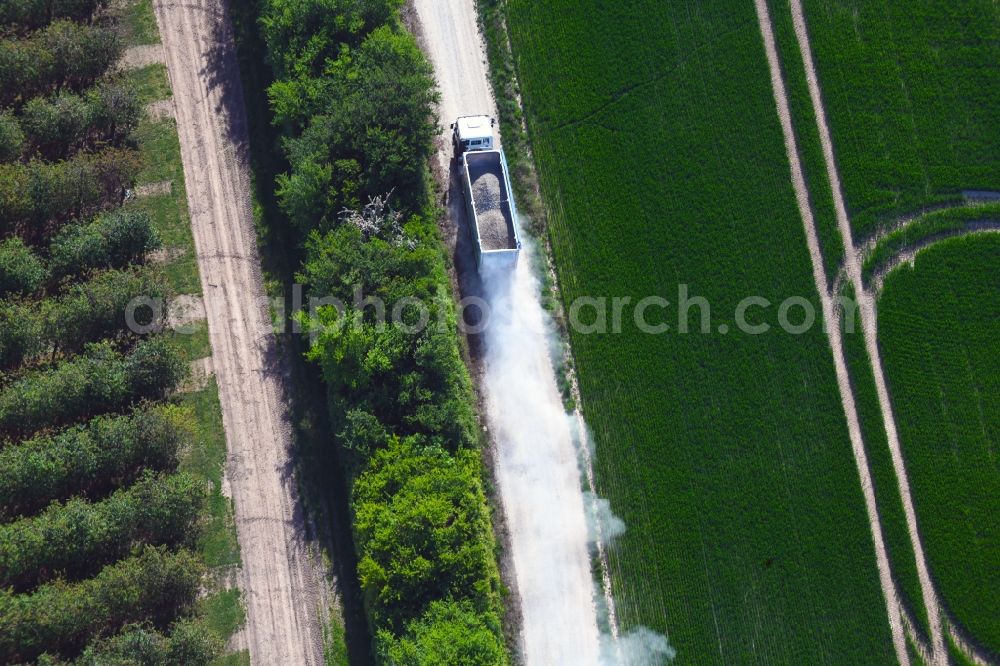 Felchta from the bird's eye view: Transport vehicles in agricultural fields in Felchta in the state Thuringia, Germany