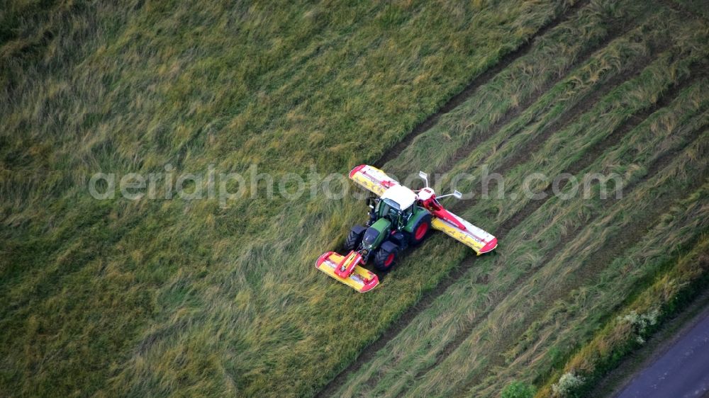 Königswinter from the bird's eye view: Tractor with an agricultural mower in the state North Rhine-Westphalia, Germany