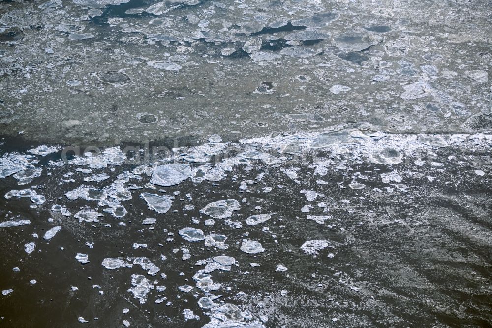 Friedrichskoog from the bird's eye view: Ice floe pieces of a drift ice layer on the water surface on the North Sea in Friedrichskoog in the state Schleswig-Holstein, Germany