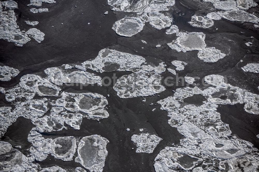 Aerial image Friedrichskoog - Ice floe pieces of a drift ice layer on the water surface on the North Sea in Friedrichskoog in the state Schleswig-Holstein, Germany