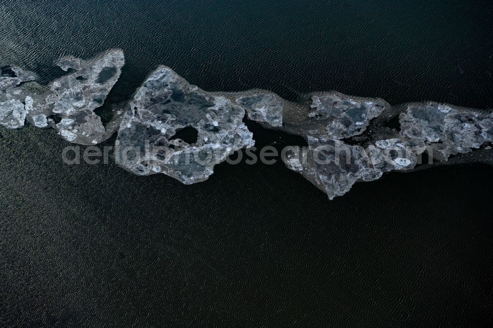 Memmert from the bird's eye view: Ice floe pieces of a drift ice layer on the water surface in Wattenmeer of Nordsee vor of Island Memmert in the state Lower Saxony, Germany