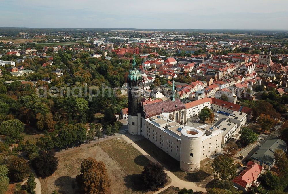 Aerial photograph Lutherstadt Wittenberg - Castle church of Wittenberg. The castle with high Gothic tower at the west end of the town is a UNESCO World Heritage Site. It gained fame as the Wittenberg Augustinian monk and theology professor Martin Luther spread his disputation