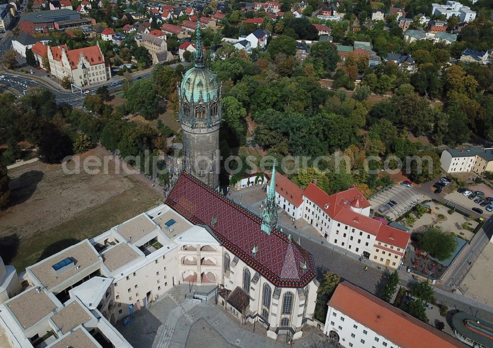 Lutherstadt Wittenberg from above - Castle church of Wittenberg. The castle with high Gothic tower at the west end of the town is a UNESCO World Heritage Site. It gained fame as the Wittenberg Augustinian monk and theology professor Martin Luther spread his disputation