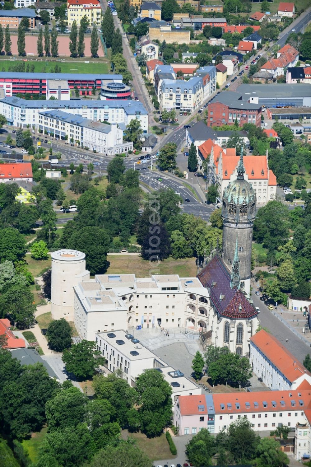 Aerial image Lutherstadt Wittenberg - Castle church of Wittenberg. The castle with its 88 m high Gothic tower at the west end of the town is a UNESCO World Heritage Site. It gained fame as the Wittenberg Augustinian monk and theology professor Martin Luther spread his disputation
