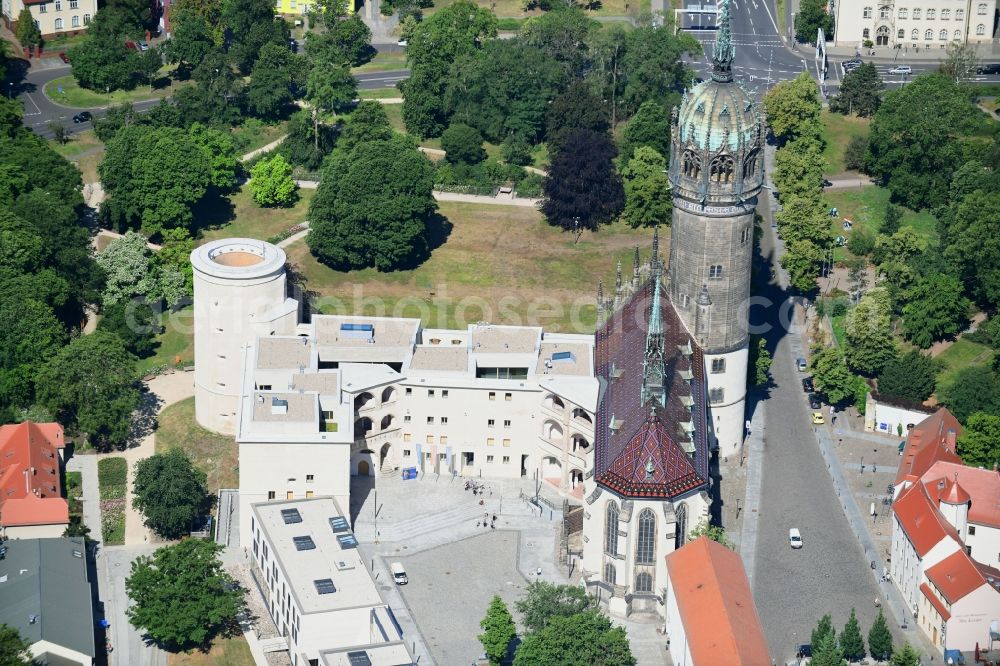 Lutherstadt Wittenberg from above - Castle church of Wittenberg. The castle with its 88 m high Gothic tower at the west end of the town is a UNESCO World Heritage Site. It gained fame as the Wittenberg Augustinian monk and theology professor Martin Luther spread his disputation
