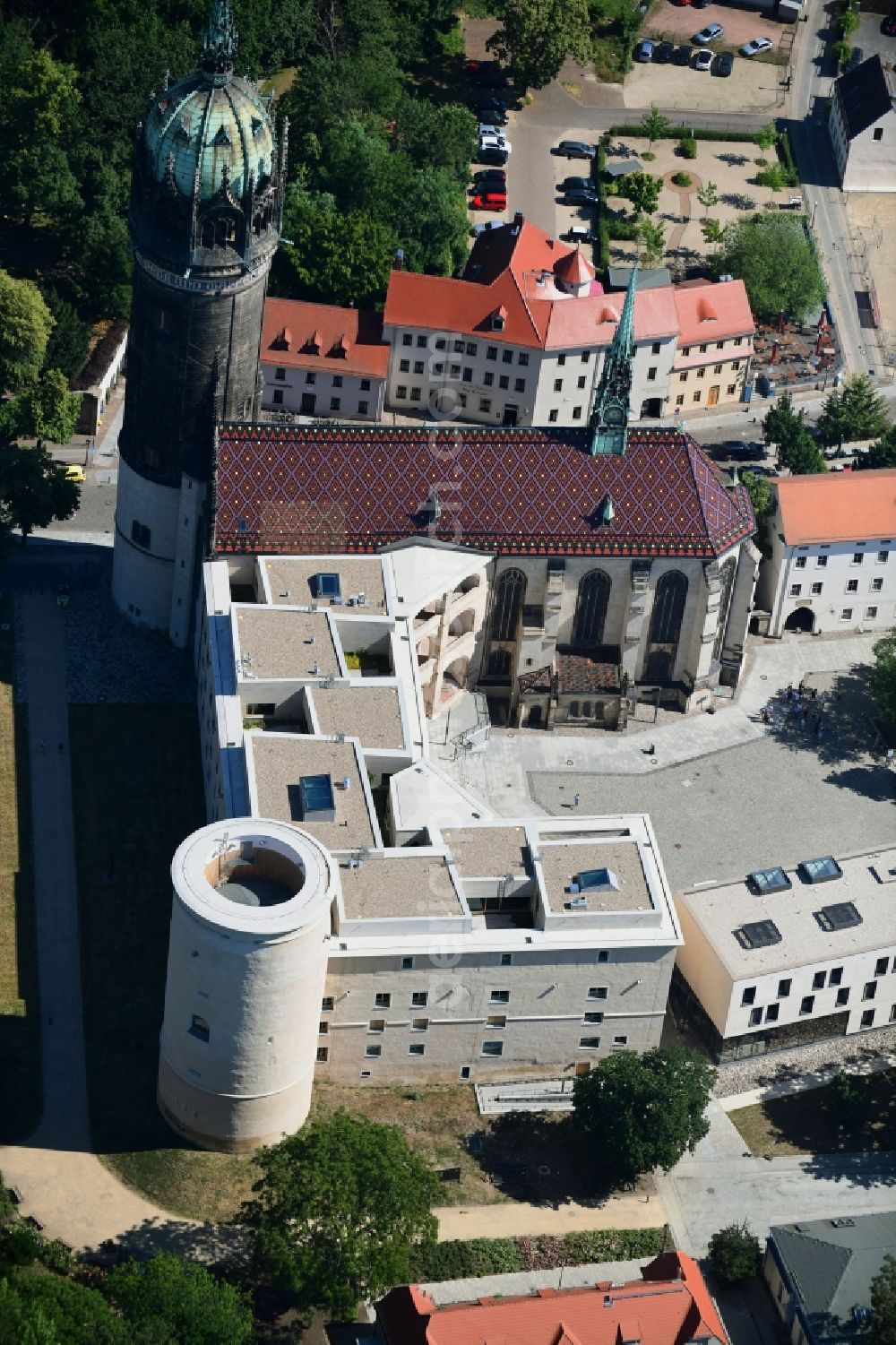 Lutherstadt Wittenberg from above - Castle church of Wittenberg. The castle with its 88 m high Gothic tower at the west end of the town is a UNESCO World Heritage Site. It gained fame as the Wittenberg Augustinian monk and theology professor Martin Luther spread his disputation