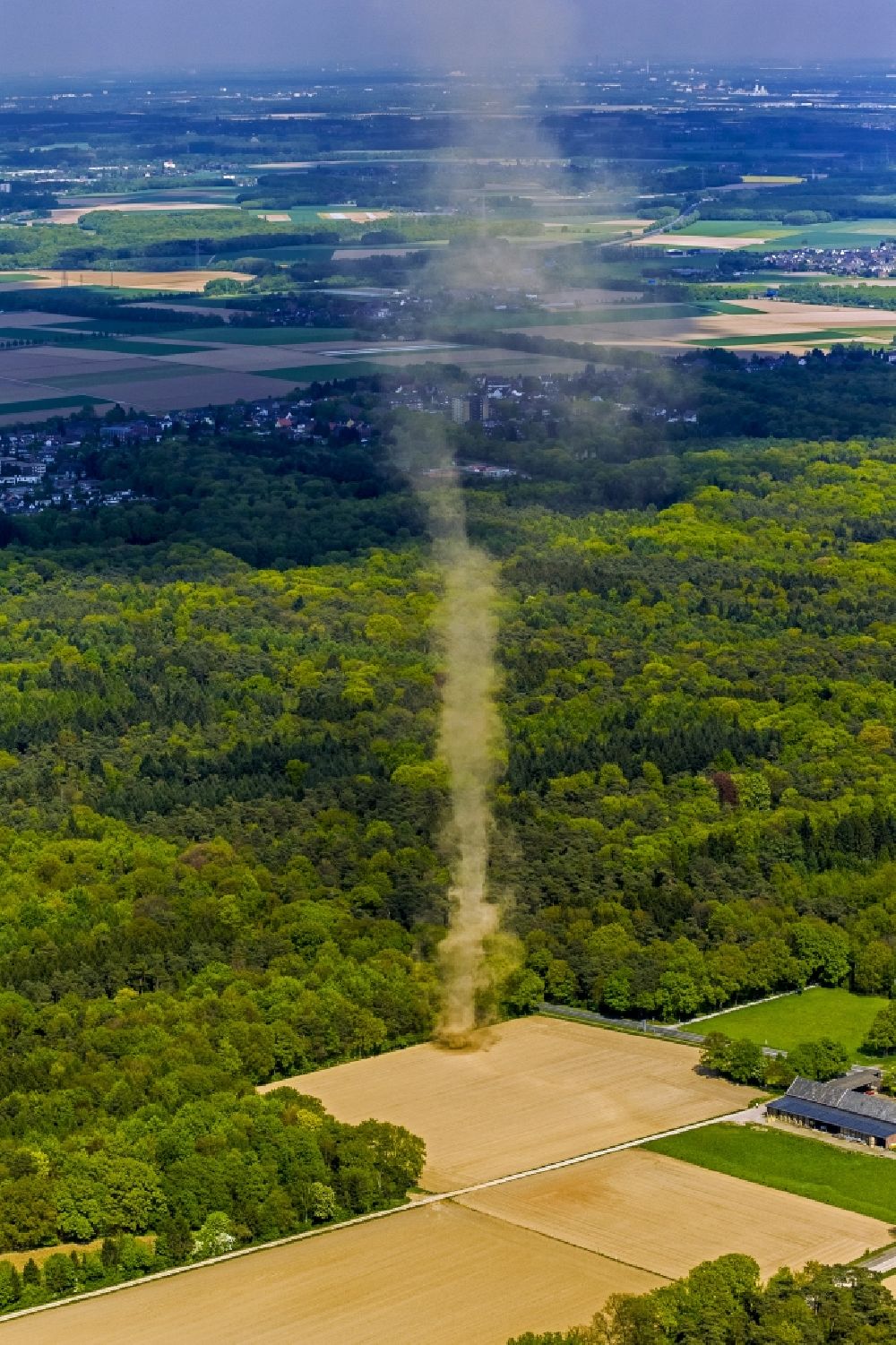 Mönchengladbach from above - A tower-type hose of a high sand swirling wind rose on a field near Moenchengladbach in North Rhine-Westphalia