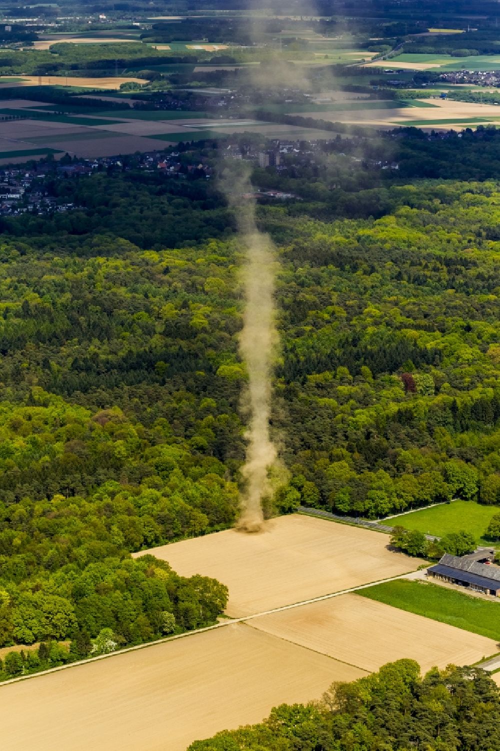 Aerial image Mönchengladbach - A tower-type hose of a high sand swirling wind rose on a field near Moenchengladbach in North Rhine-Westphalia