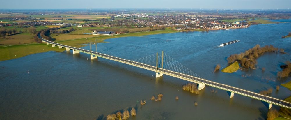 Kalkar from above - Shore areas with flooded by flood level riverbed on rhine bridgde in Rees in the state North Rhine-Westphalia