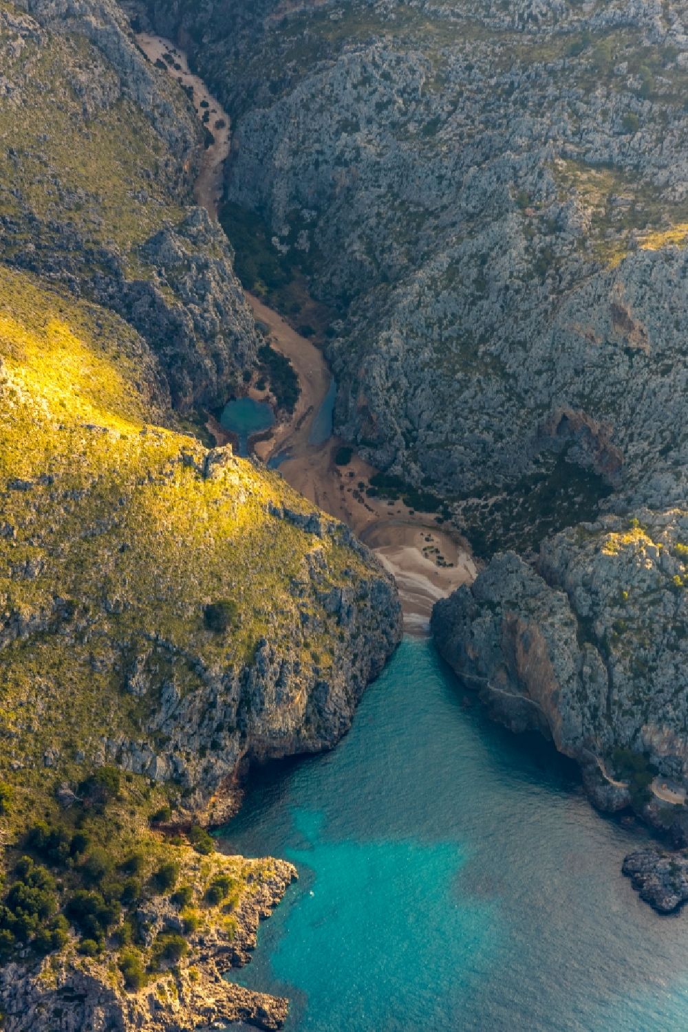 Escorca from above - Riparian areas along the river mouth of Torrent de Pareis in Escorca in Balearic island of Mallorca, Spain