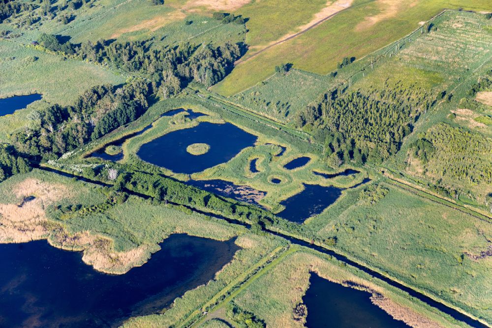 Linum from the bird's eye view: Shore areas of the ponds for fish farming in Linum in the state Brandenburg, Germany