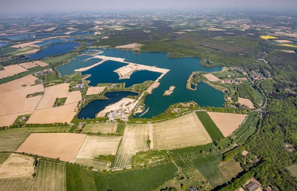 Vahnum from the bird's eye view: Shore areas of the ponds for fish farming in Vahnum in the state North Rhine-Westphalia, Germany