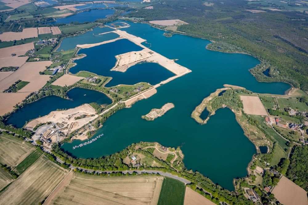 Vahnum from the bird's eye view: Shore areas of the ponds for fish farming in Vahnum in the state North Rhine-Westphalia, Germany