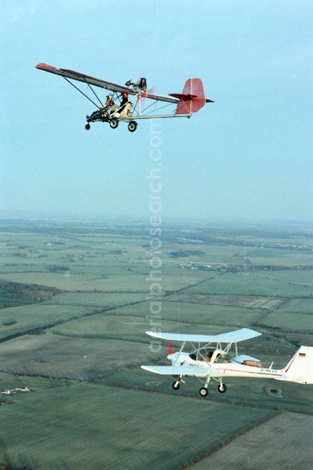 Aerial photograph Eggersdorf - Ultralight aircraft in flight above the sky MISTRAL with the identifier D-MVVV in formation with a skywalker airplane in Eggersdorf in the state Brandenburg, Germany
