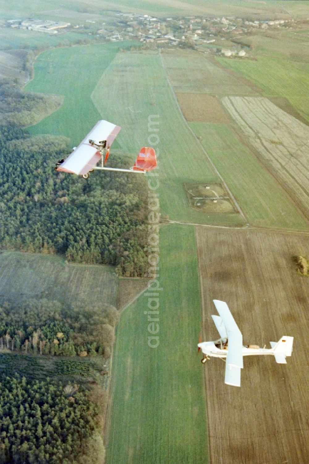 Eggersdorf from above - Ultralight aircraft in flight above the sky MISTRAL with the identifier D-MVVV in formation with a skywalker airplane in Eggersdorf in the state Brandenburg, Germany