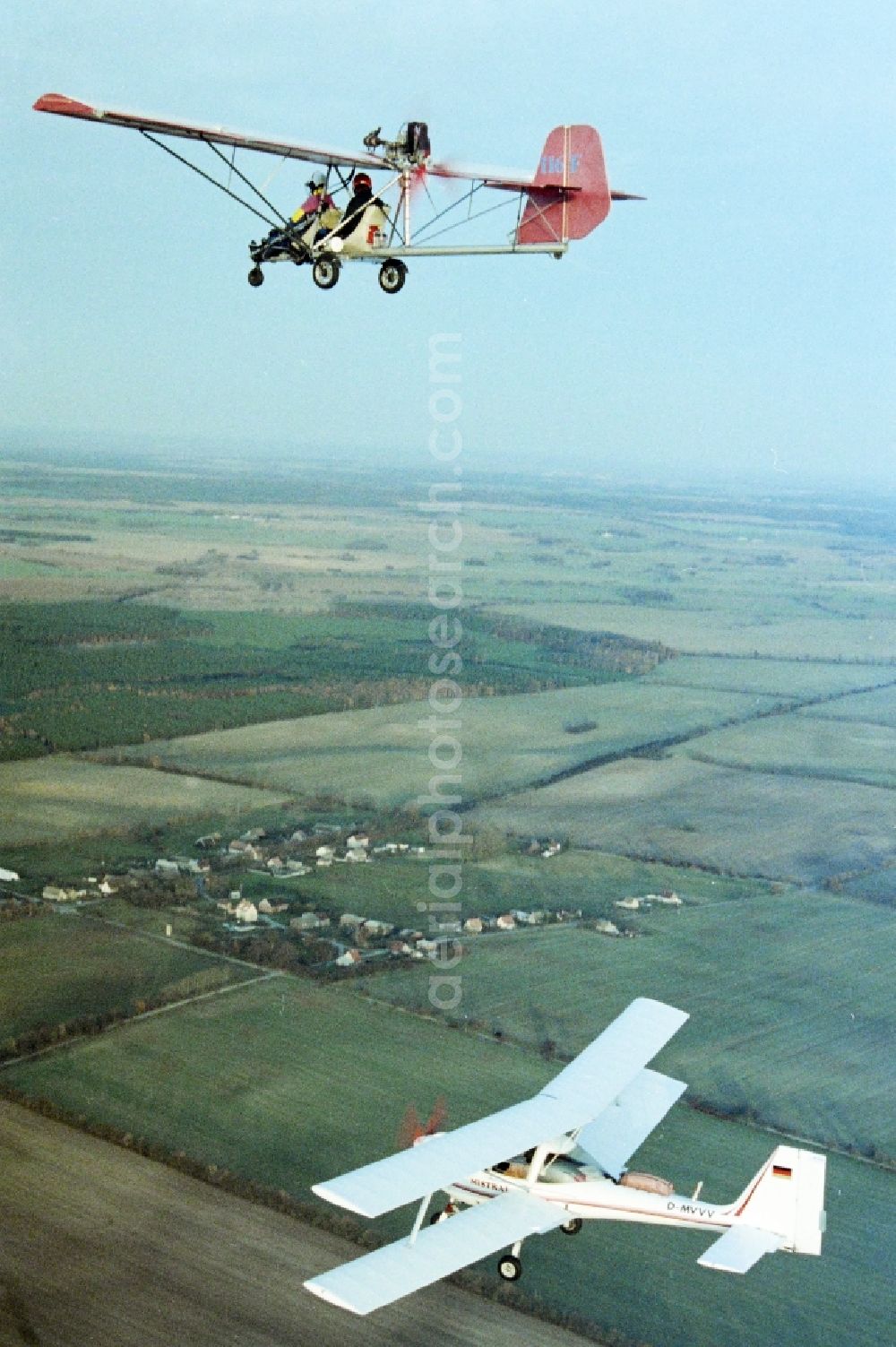 Aerial image Eggersdorf - Ultralight aircraft in flight above the sky MISTRAL with the identifier D-MVVV in formation with a skywalker airplane in Eggersdorf in the state Brandenburg, Germany