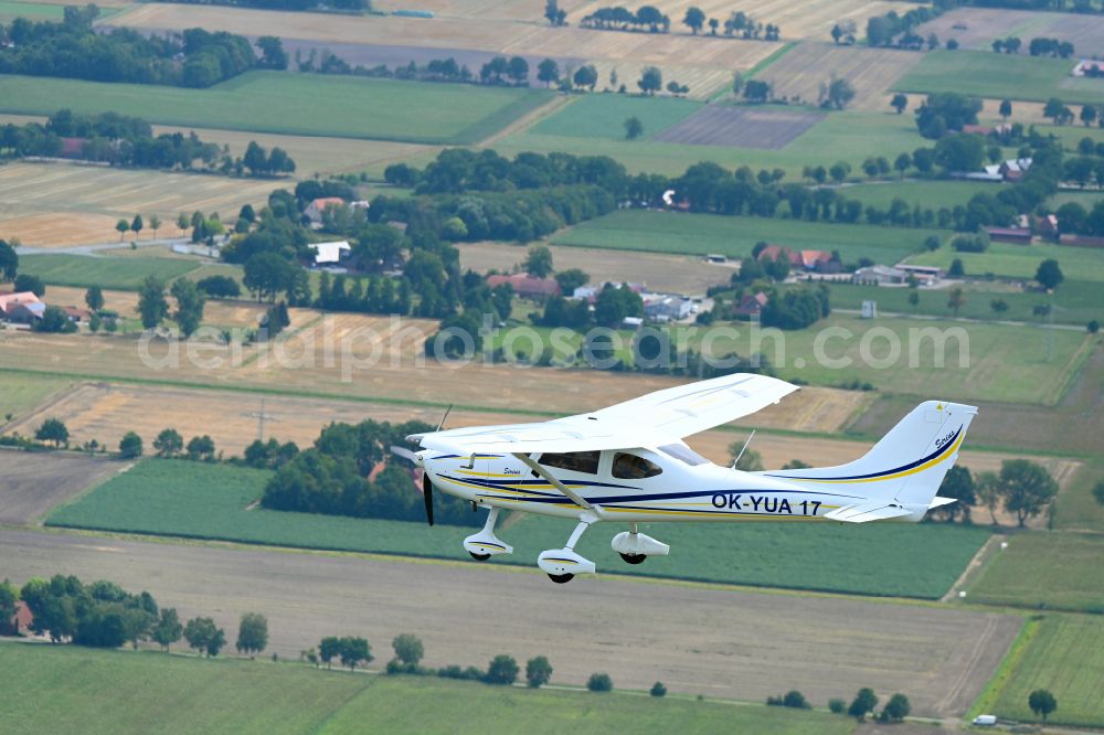 Aerial photograph Wagenfeld - Ultralight aircraft TL-3000 Sirius with the identifier OK-YUA17 in flight above the sky in Wagenfeld in the state Lower Saxony, Germany