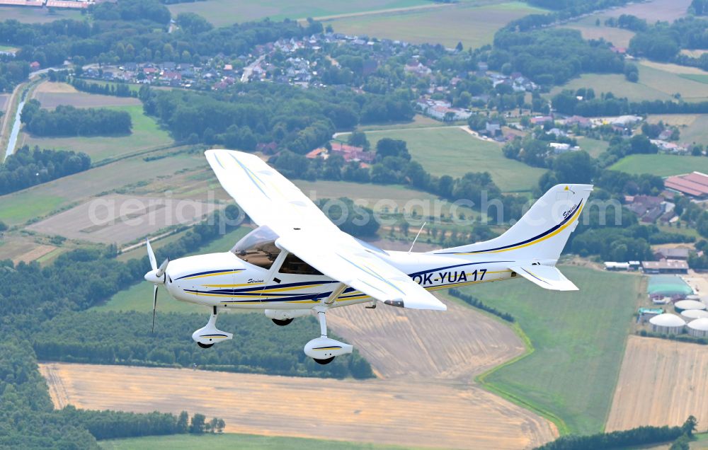 Wagenfeld from above - Ultralight aircraft TL-3000 Sirius with the identifier OK-YUA17 in flight above the sky in Wagenfeld in the state Lower Saxony, Germany
