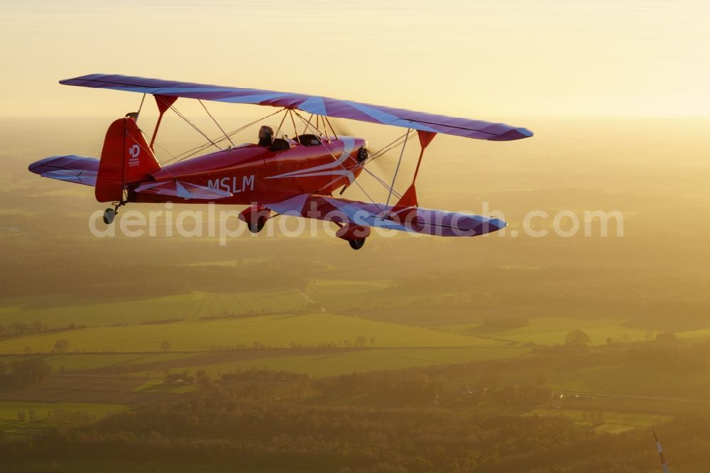 Aerial photograph Oldendorf - Microlight aircraft Sunwheel D-MSLM while sunset over the lakes of moor near Oldendorf in Lower Saxony, Germany