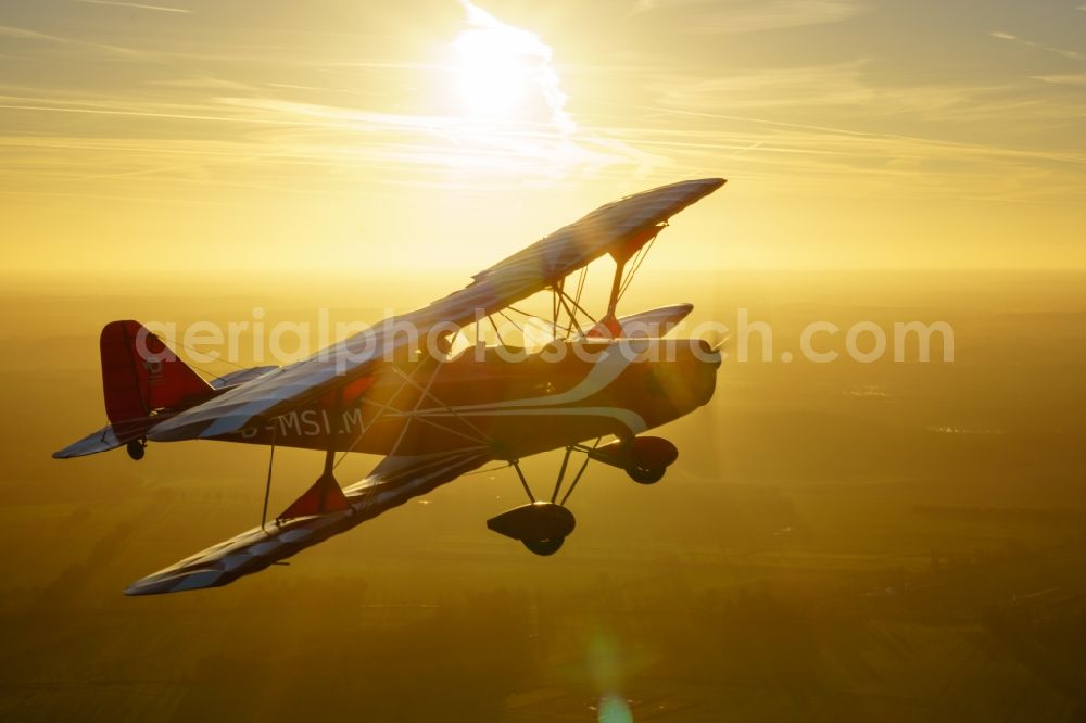 Oldendorf from above - Microlight aircraft Sunwheel D-MSLM while sunset over the lakes of moor near Oldendorf in Lower Saxony, Germany