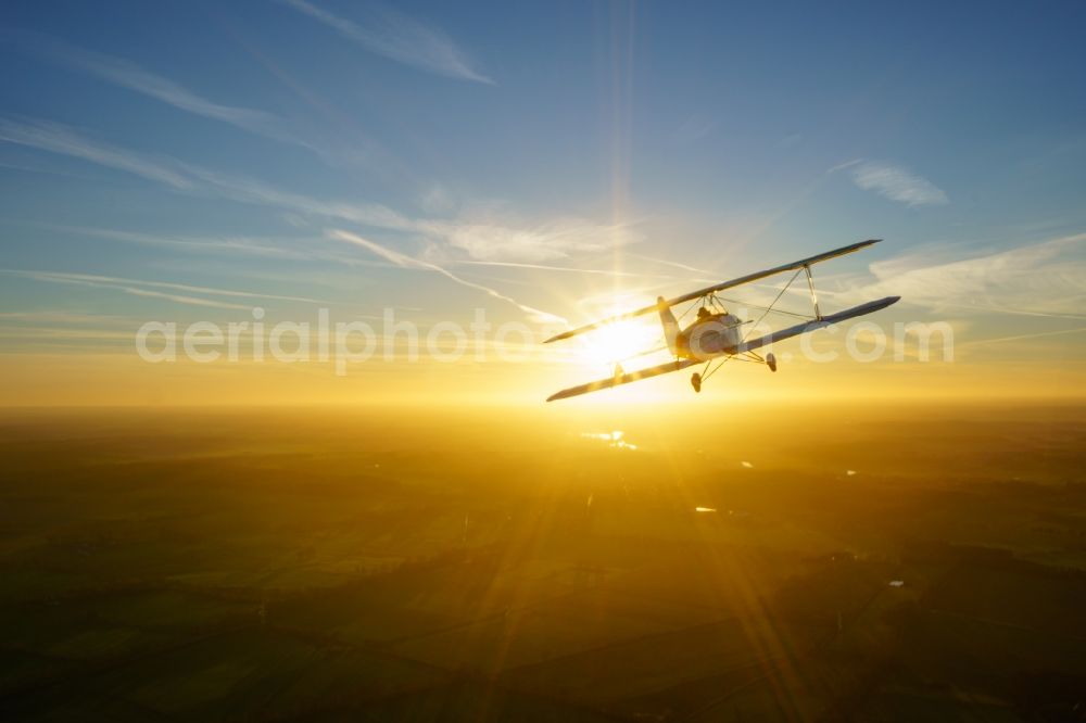Aerial photograph Oldendorf - Microlight aircraft Sunwheel D-MSLM while sunset over the lakes of moor near Oldendorf in Lower Saxony, Germany