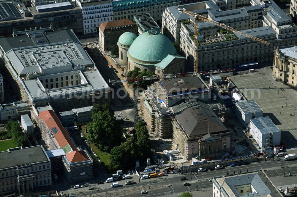 Berlin from above - View of the reconstruction and renovation of the building of the Staatsoper Unter den Linden in Berlin at Bebelplatz. It is the oldest opera house and theater building in Berlin. A new building will serve as stacks and warehouse for the Staatsoper Komplex. The architect HG Merz is a overseeing the reconstruction of the historical building complex