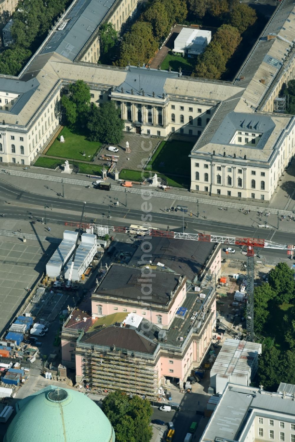Berlin from the bird's eye view: Reconstruction and renovation of the building of the Staatsoper Unter den Linden in Berlin at Bebelplatz. It is the oldest opera house and theater building in Berlin. A new building will serve as stacks and warehouse for the Staatsoper Komplex. The architect HG Merz is a overseeing the reconstruction of the historical building complex