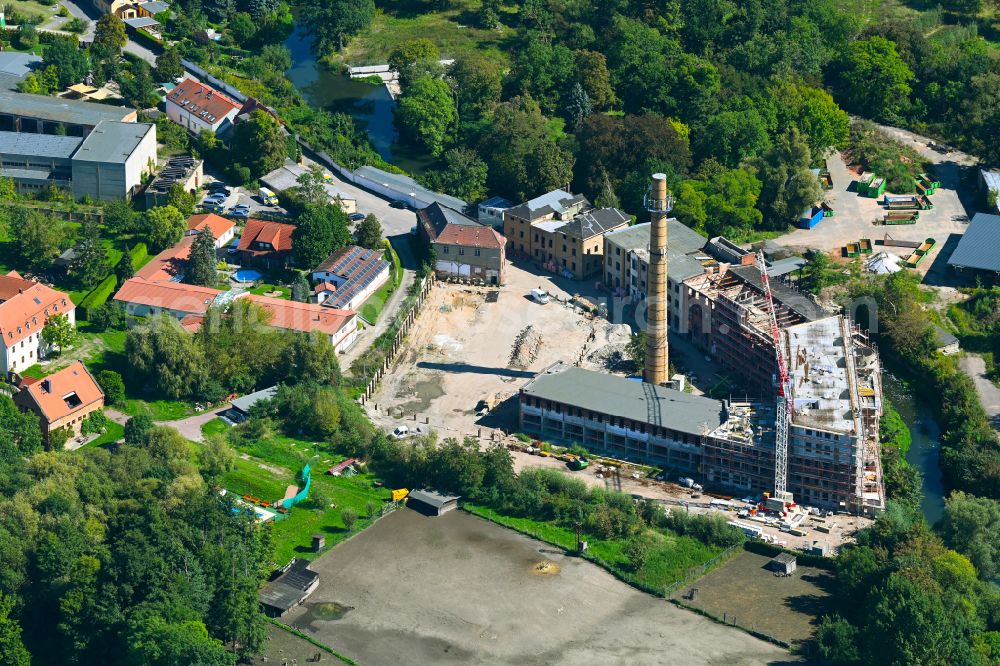 Schkeuditz from the bird's eye view: Conversion construction site to modernize and renovate the factory premises of the old paper factory on Fabrikstrasse into apartments in the district of Wehlitz in Schkeuditz in the state Saxony, Germany
