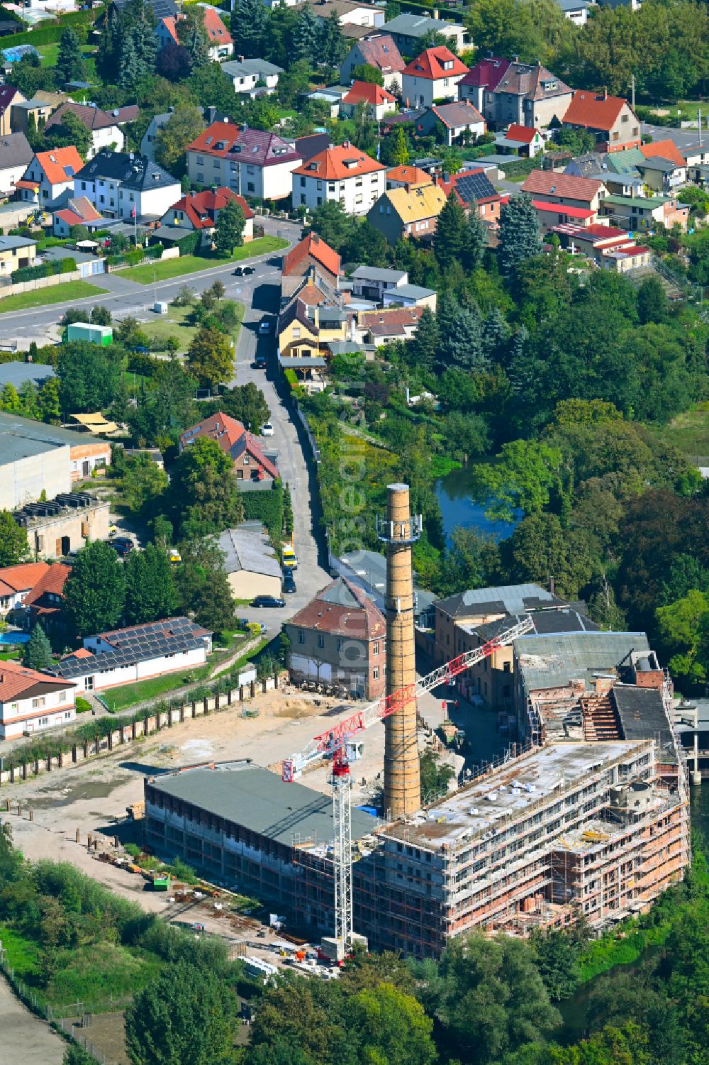 Schkeuditz from above - Conversion construction site to modernize and renovate the factory premises of the old paper factory on Fabrikstrasse into apartments in the district of Wehlitz in Schkeuditz in the state Saxony, Germany
