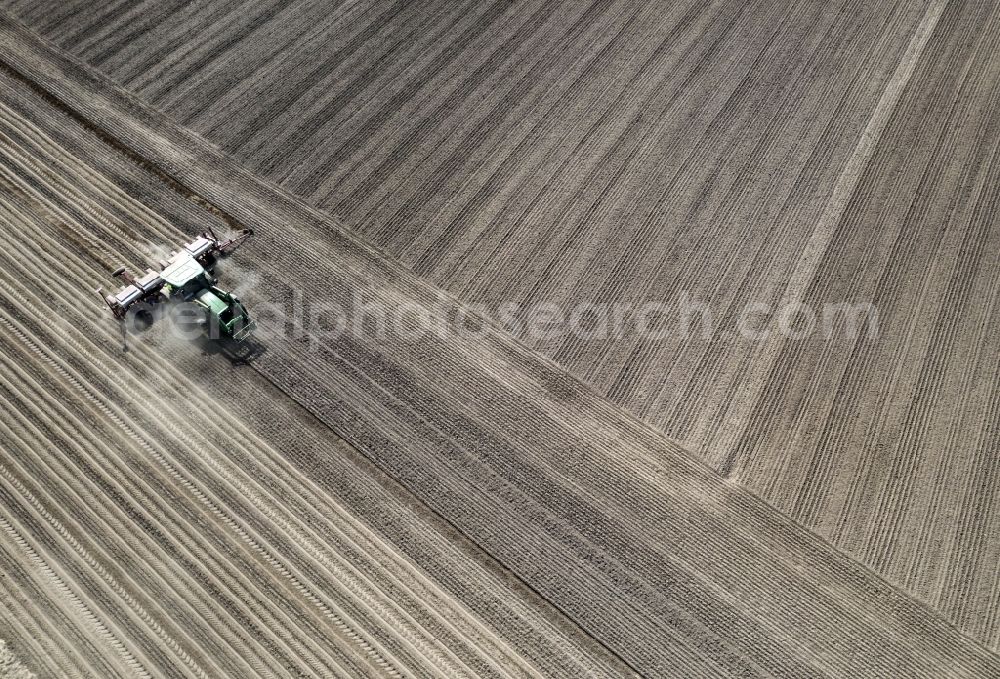 Haseloff from the bird's eye view: Plowing and shifting the earth by a tractor with plow on agricultural fields in Haseloff in the state Brandenburg, Germany