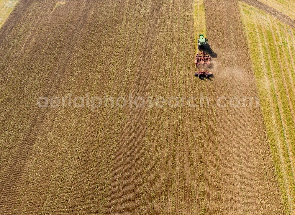 Teutschenthal from above - Plowing and shifting the earth by a tractor with plow on agricultural fields in Teutschenthal in the state Saxony-Anhalt, Germany