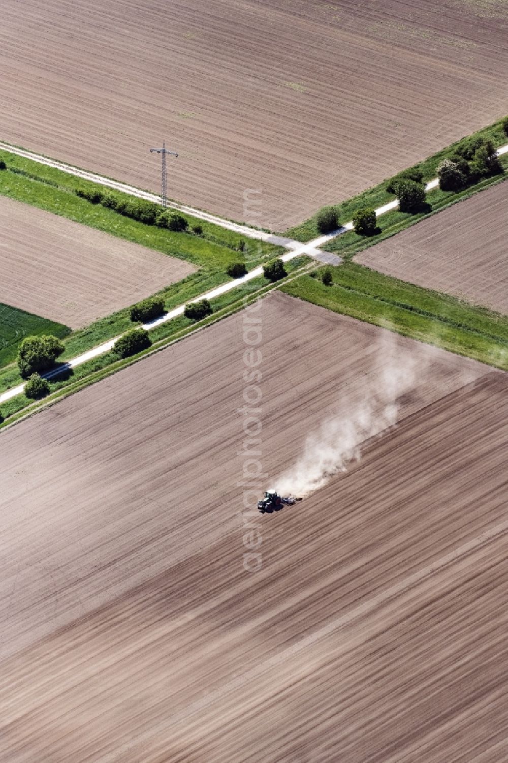 Worms from above - Plowing and shifting the earth by a tractor with plow on agricultural fields in Worms in the state Rhineland-Palatinate, Germany