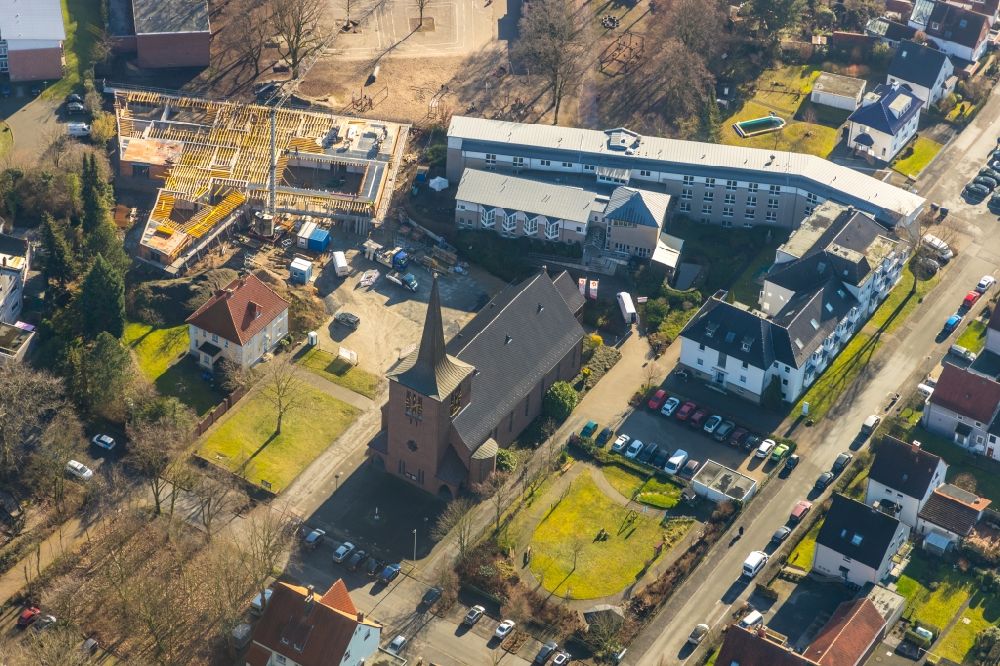 Hamm from the bird's eye view: Building of the indoor arena Haus der Begegnung for the community and all-day school overlooking the Katholische Kirche Heilig Kreuz and the Caritas-Altenheim St. Josef in the district Herringen in Hamm in the state North Rhine-Westphalia, Germany