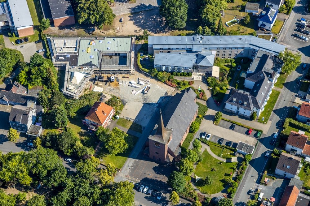Hamm from above - Building of the indoor arena Haus der Begegnung for the community and all-day school overlooking the Katholische Kirche Heilig Kreuz and the Caritas-Altenheim St. Josef in the district Herringen in Hamm in the state North Rhine-Westphalia, Germany