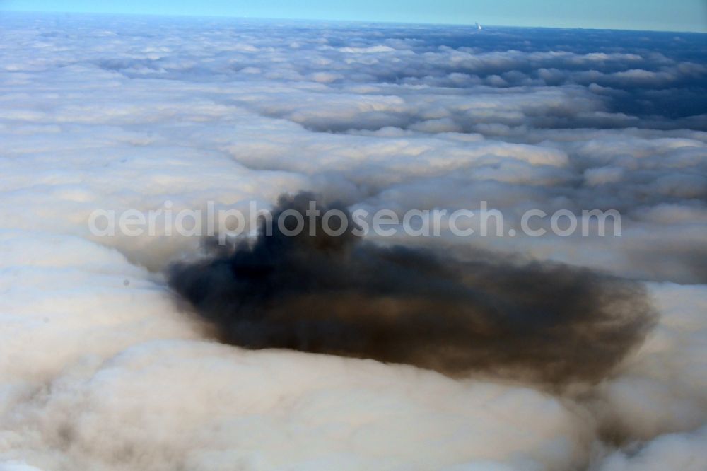 Riesa from the bird's eye view: Weather situation with cloud formation and black combustion residues in a closed covering layer of high fog over Riesa in the state Saxony, Germany